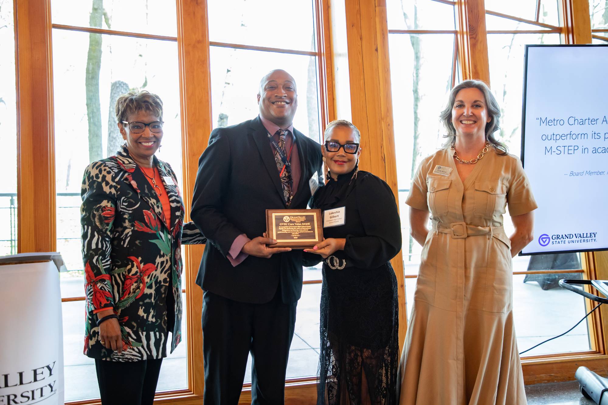 A board member and school leader from Covenant High School Grand Rapids accepting the award from members of CSO